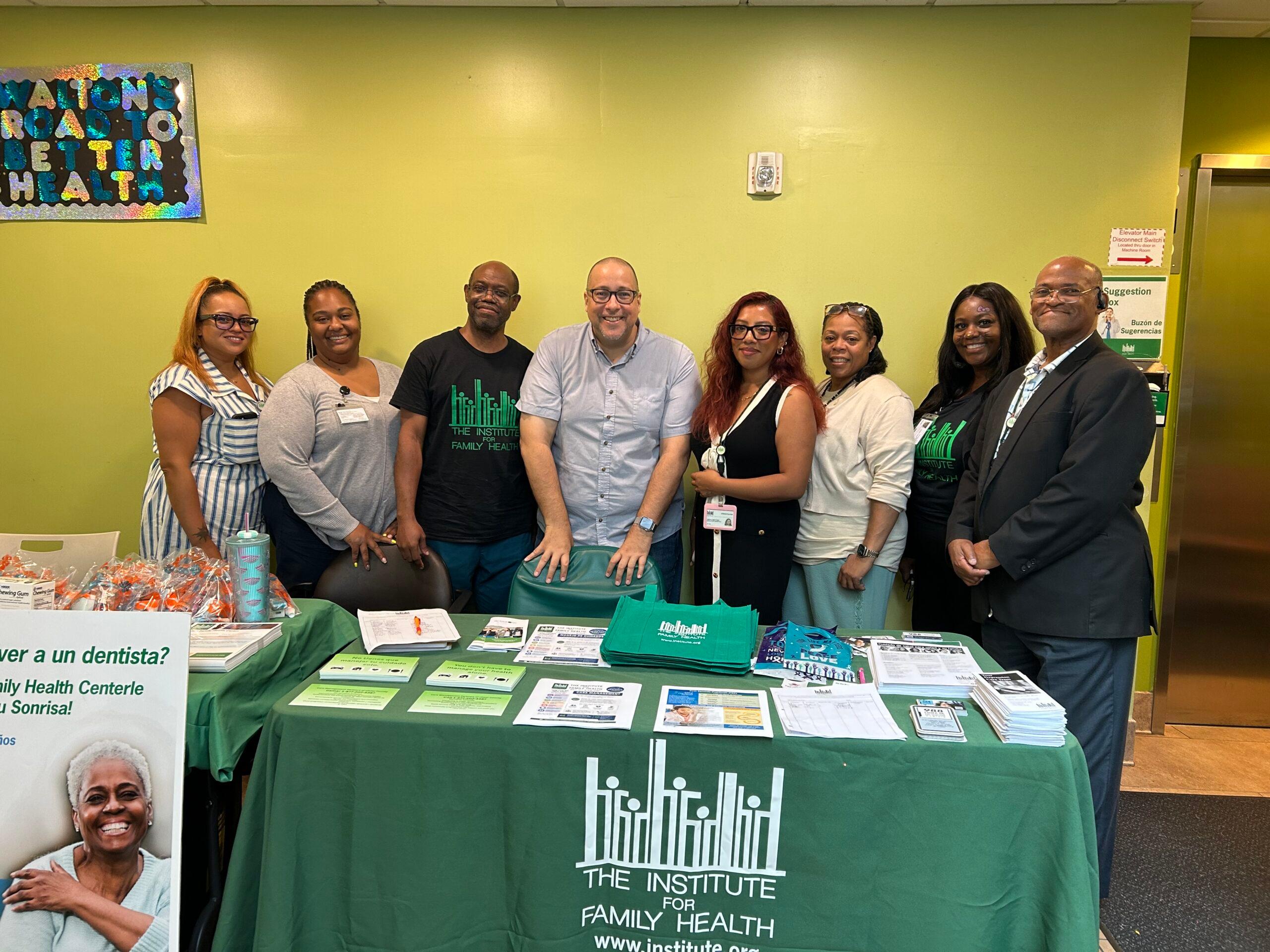 A row of people at a health fair at the Walton Family Health Center.