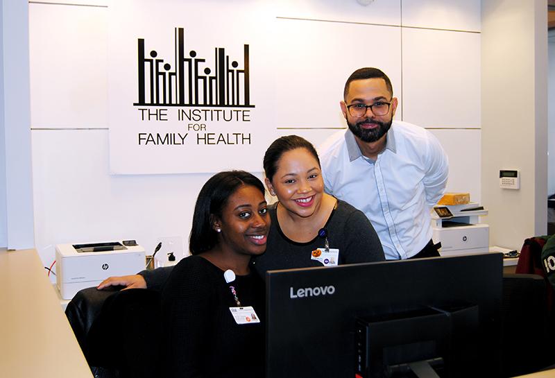 Health Center Staff Smiling at Front Desk