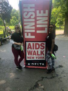 Women standing next to "Finish line" sign.
